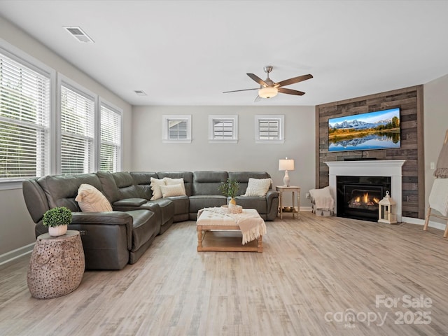 5013 Hamilton Mill Dr, Waxhaw, NC 28173 - living area with wood finished floors, a ceiling fan, and a glass covered fireplace