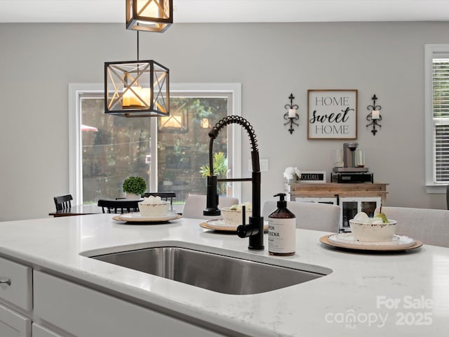 5013 Hamilton Mill Dr, Waxhaw, NC 28173 - detailed view of decorative light fixtures, white cabinets, and light stone counters