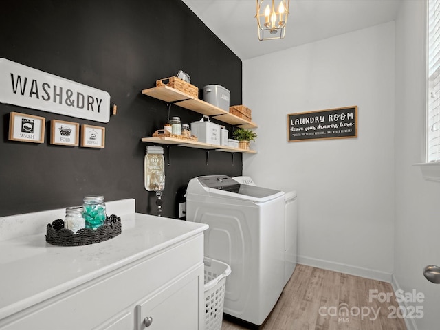 5013 Hamilton Mill Dr, Waxhaw, NC 28173 - washroom featuring washer and clothes dryer, light wood-type flooring, a chandelier, and cabinet space