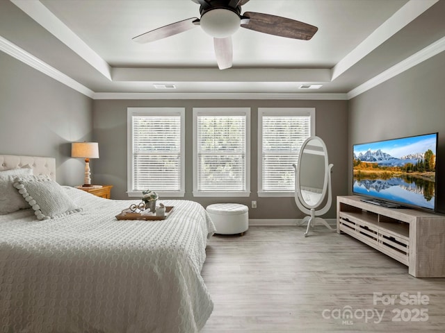 5013 Hamilton Mill Dr, Waxhaw, NC 28173 - bedroom featuring a raised ceiling, wood finished floors, crown molding, and a ceiling fan