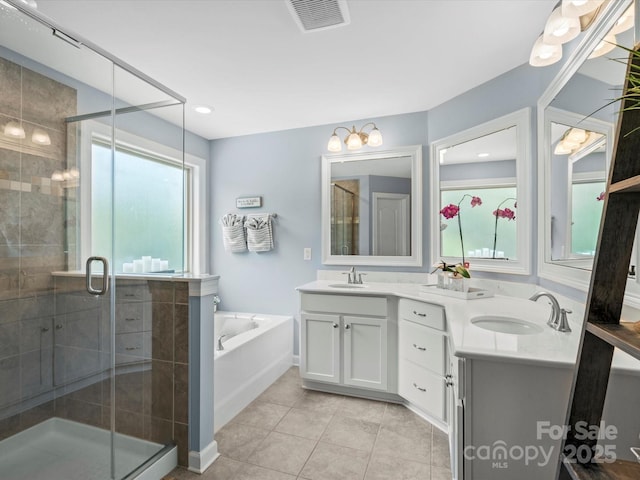 5013 Hamilton Mill Dr, Waxhaw, NC 28173 - full bath with healthy amount of natural light, double vanity, a garden tub, and a shower stall