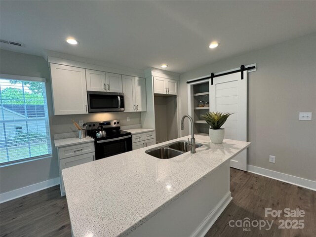 2012 Crown Point Dr Unit A, Albemarle, NC 28001 - kitchen featuring stainless steel microwave, electric stove, a sink, dark wood-style flooring, and baseboards