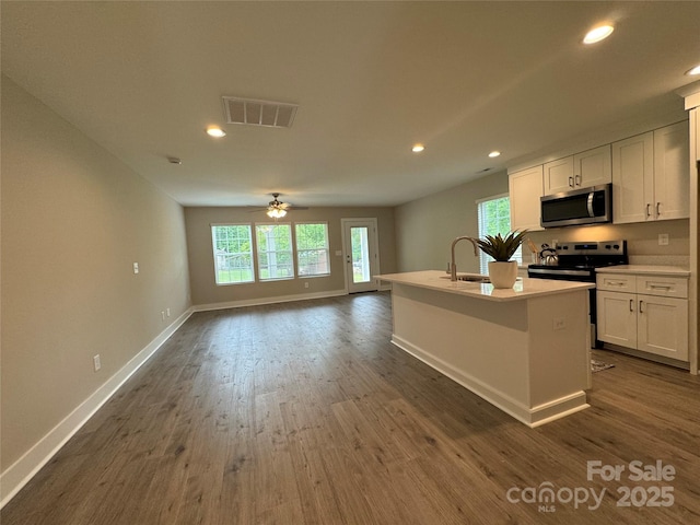 2012 Crown Point Dr Unit A, Albemarle, NC 28001 - kitchen with stainless steel appliances, a sink, baseboards, ceiling fan, and dark wood-style floors