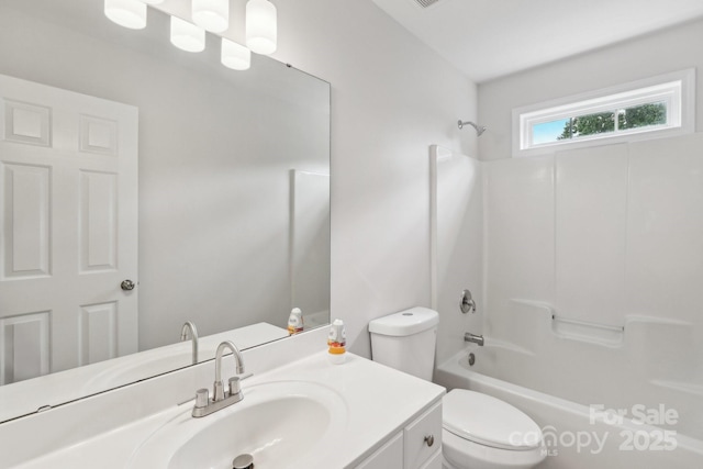 bathroom with toilet, vanity, and shower / bath combination