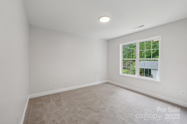 carpeted empty room with baseboards