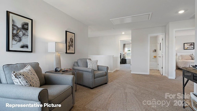 carpeted living room featuring attic access, baseboards, and recessed lighting