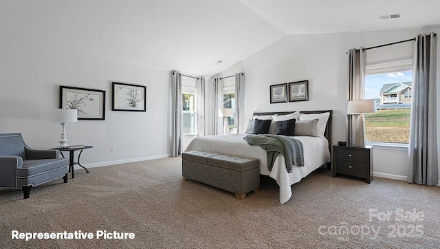 carpeted bedroom with lofted ceiling and baseboards