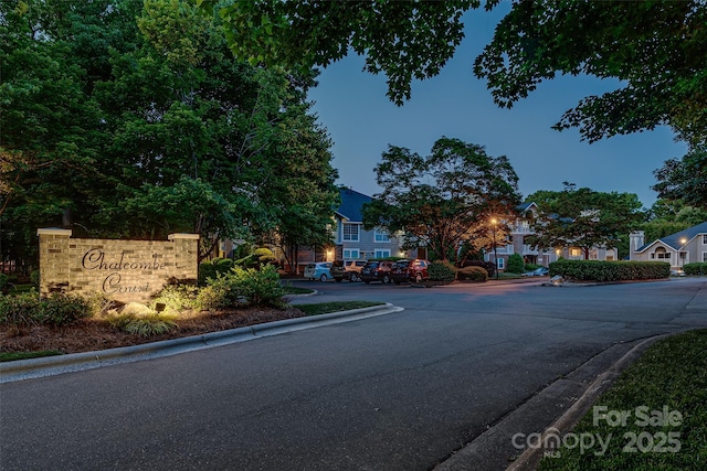 view of asphalt road featuring curbs