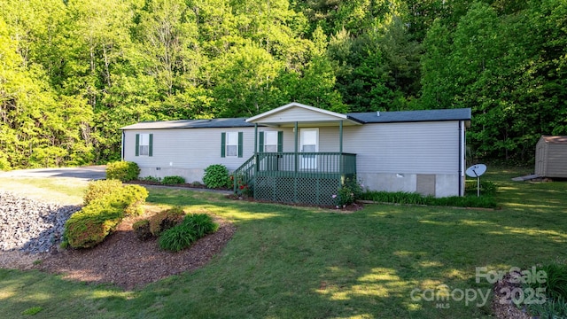 2930 Clarks Chapel Rd, Lenoir, NC 28645 - manufactured / mobile home featuring a front yard, crawl space, a forest view, a shed, and an outdoor structure
