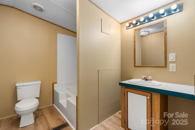 2930 Clarks Chapel Rd, Lenoir, NC 28645 - bathroom with wood finished floors, vanity, toilet, a bath, and lofted ceiling