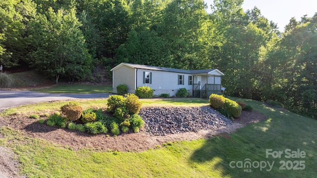 2930 Clarks Chapel Rd, Lenoir, NC 28645 - manufactured / mobile home with a front lawn and a forest view