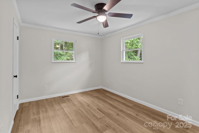 unfurnished room featuring light wood-style flooring, ornamental molding, baseboards, and a ceiling fan