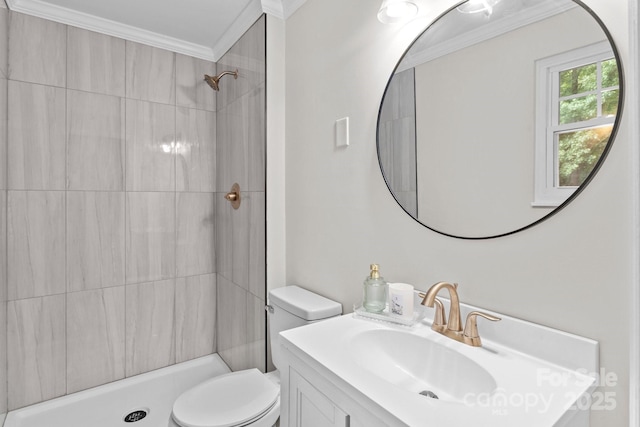 full bathroom with crown molding, a tile shower, toilet, and vanity