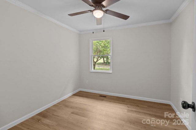 unfurnished room with baseboards, light wood-style flooring, a ceiling fan, and crown molding