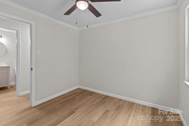 empty room featuring baseboards, light wood finished floors, ceiling fan, and crown molding