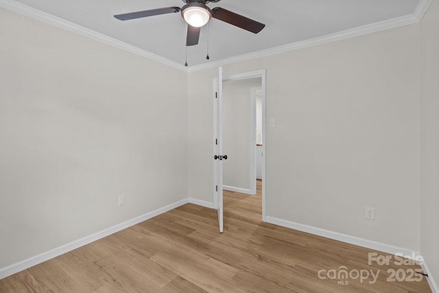 spare room featuring ceiling fan, light wood-style floors, baseboards, and ornamental molding