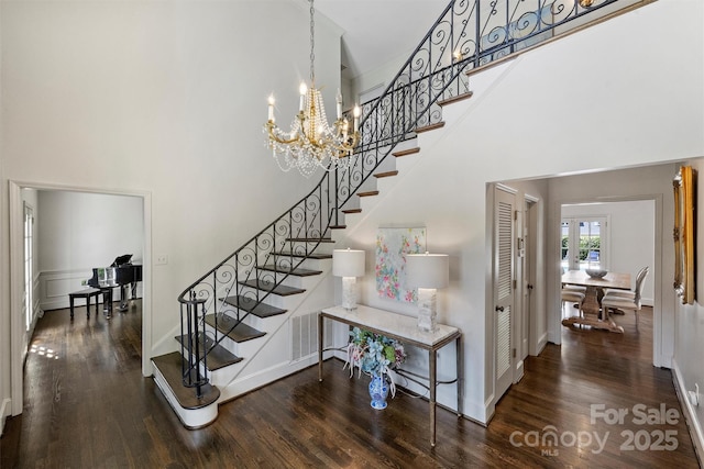 5806 Bentway Dr, Charlotte, NC 28226 - staircase featuring a chandelier, wood finished floors, a high ceiling, and baseboards