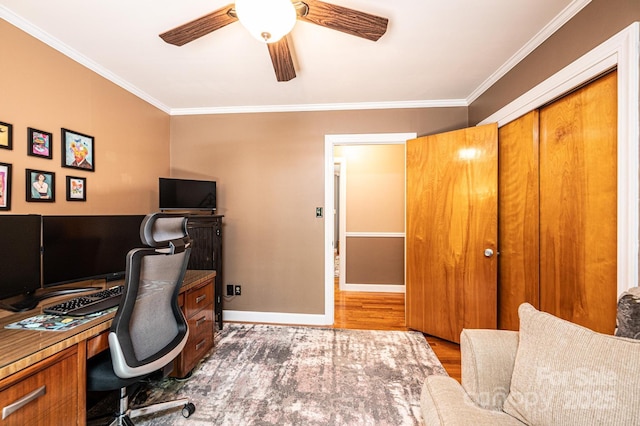 office area with ornamental molding, ceiling fan, baseboards, and wood finished floors