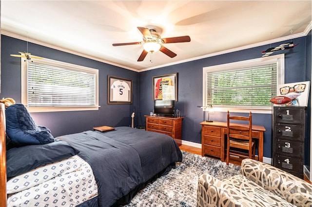 bedroom featuring wood finished floors, ornamental molding, a ceiling fan, and baseboards