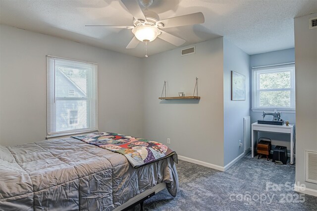 bedroom featuring carpet, baseboards, a ceiling fan, and a textured ceiling