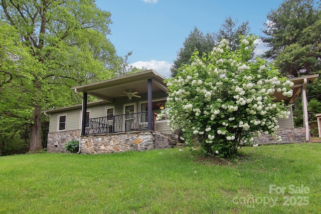 51 Atari Rd, Waynesville, NC 28786 - view of front of property with ceiling fan, a front yard, stone siding, and covered porch