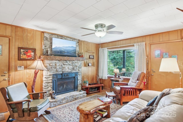 51 Atari Rd, Waynesville, NC 28786 - living area with wooden walls, ceiling fan, a fireplace, and ornamental molding