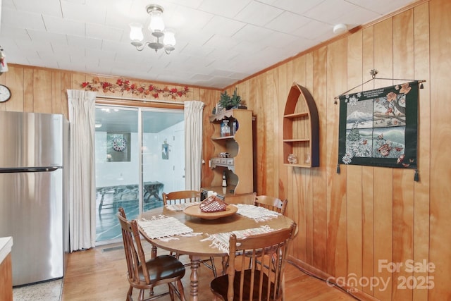 51 Atari Rd, Waynesville, NC 28786 - dining space featuring wooden walls, built in features, ornamental molding, and light wood-style flooring