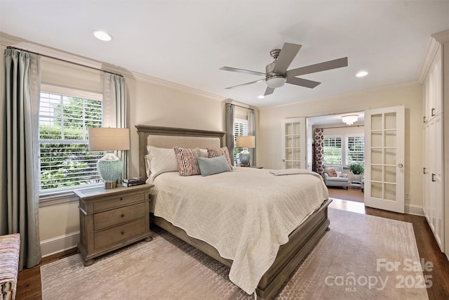 bedroom featuring french doors, crown molding, wood finished floors, baseboards, and recessed lighting