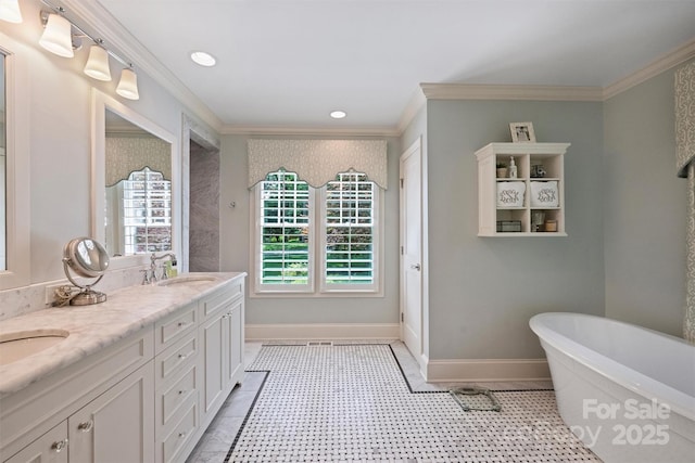 bathroom with crown molding, a freestanding tub, double vanity, recessed lighting, and tile patterned flooring