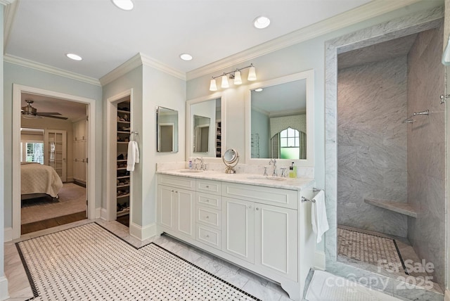 bathroom with double vanity, walk in shower, crown molding, ceiling fan, and recessed lighting