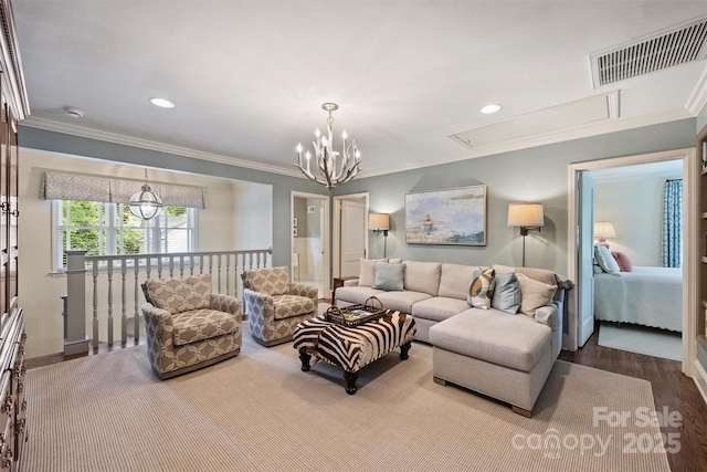 living room featuring crown molding, attic access, a chandelier, recessed lighting, and wood finished floors