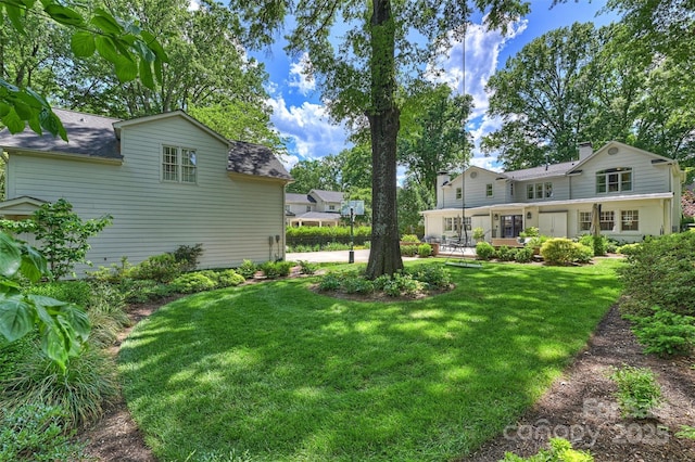 view of green lawn featuring a patio area
