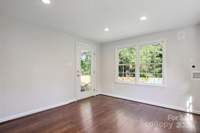 empty room featuring baseboards, dark wood-style flooring, and recessed lighting