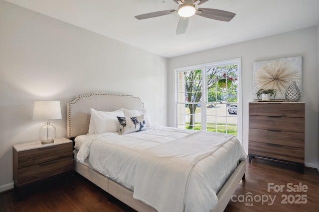 bedroom featuring wood finished floors, baseboards, and a ceiling fan