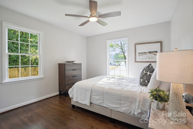 bedroom featuring wood finished floors, baseboards, and a ceiling fan
