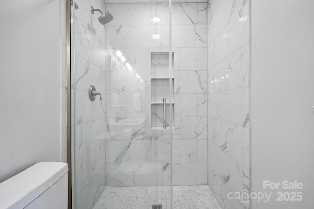 bathroom with toilet and a stall shower
