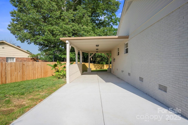 view of patio / terrace with driveway and a carport