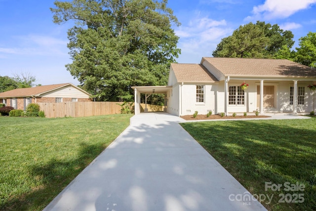 single story home featuring concrete driveway, a carport, a porch, and a shingled roof
