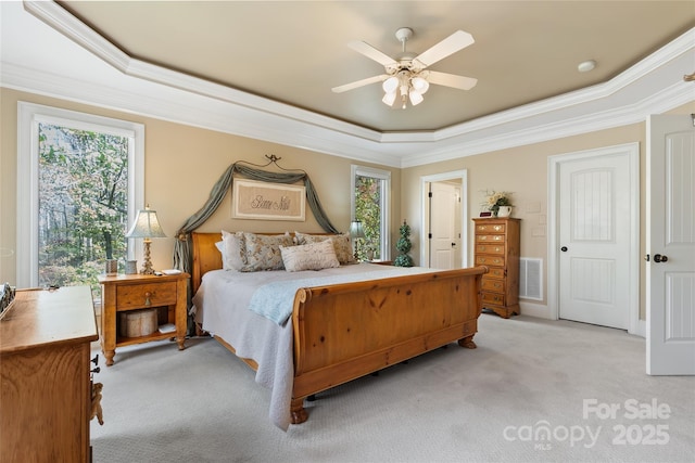 20017 Bragg, Chapel Hill, NC 27517 - bedroom with a tray ceiling, light colored carpet, crown molding, multiple windows, and a ceiling fan