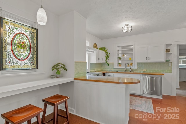 30 Joyner Ave, Asheville, NC 28806 - kitchen with stainless steel dishwasher, backsplash, open shelves, white cabinetry, and a sink