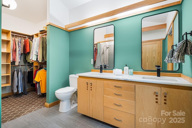 18 Balsam Ct, Arden, NC 28704 - full bathroom featuring double vanity, toilet, a walk in closet, and a shower with door