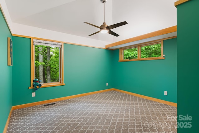 18 Balsam Ct, Arden, NC 28704 - spare room featuring ceiling fan, plenty of natural light, baseboards, vaulted ceiling, and carpet flooring