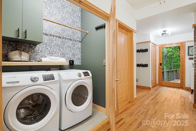 18 Balsam Ct, Arden, NC 28704 - washroom featuring washing machine and clothes dryer, light wood-style flooring, baseboards, and cabinet space