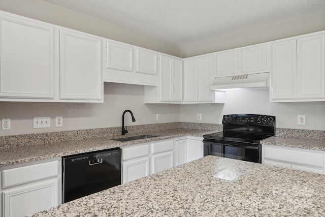 kitchen featuring black appliances, under cabinet range hood, a sink, white cabinetry, and a textured ceiling