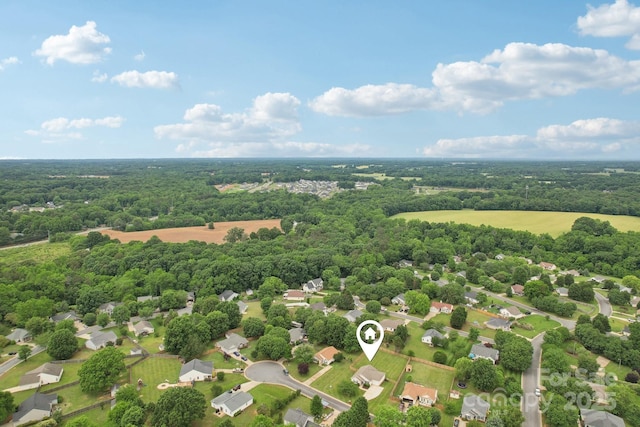 aerial perspective of suburban area featuring a forest