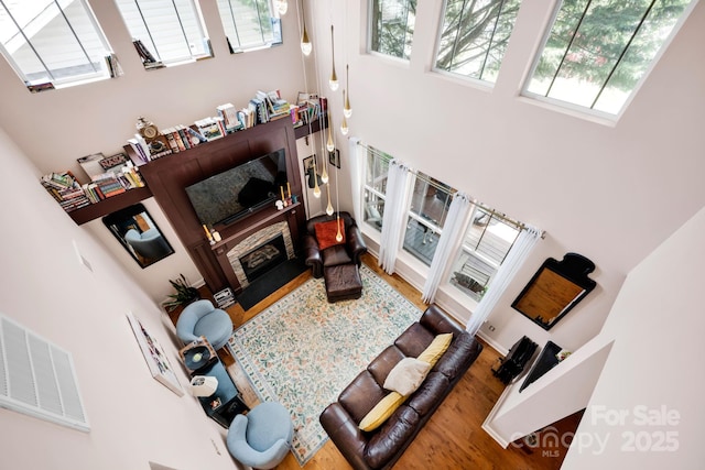 14940 Carbert Ln, Huntersville, NC 28078 - living area with a high ceiling, wood finished floors, and a glass covered fireplace