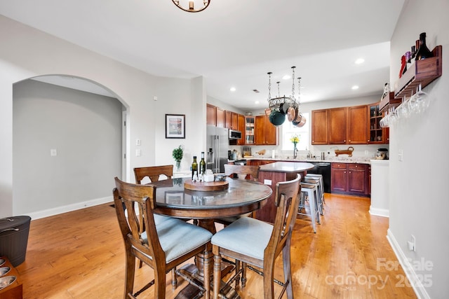 14940 Carbert Ln, Huntersville, NC 28078 - dining space with arched walkways, light wood-type flooring, recessed lighting, and baseboards