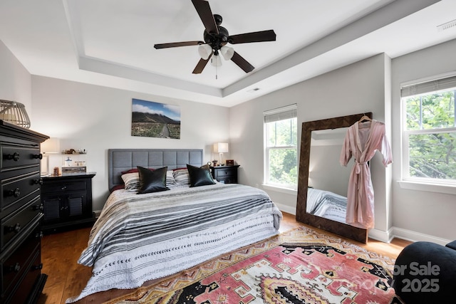 14940 Carbert Ln, Huntersville, NC 28078 - bedroom with a tray ceiling, wood finished floors, a ceiling fan, and baseboards