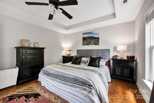 14940 Carbert Ln, Huntersville, NC 28078 - bedroom featuring wood finished floors, a raised ceiling, and a ceiling fan