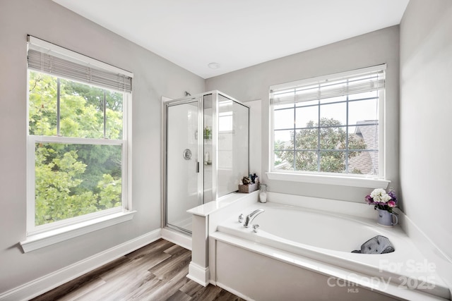 14940 Carbert Ln, Huntersville, NC 28078 - bathroom featuring a garden tub, a stall shower, and wood finished floors